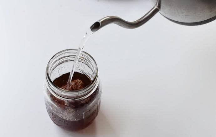 Pouring water in a mason jar