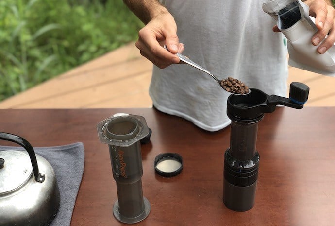 adding coffee beans to grinder