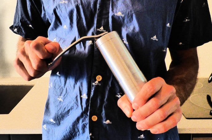 Person holding coffee grinder