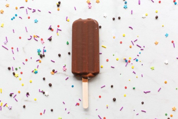 ice cream popsicle on a counter with some sprinkles