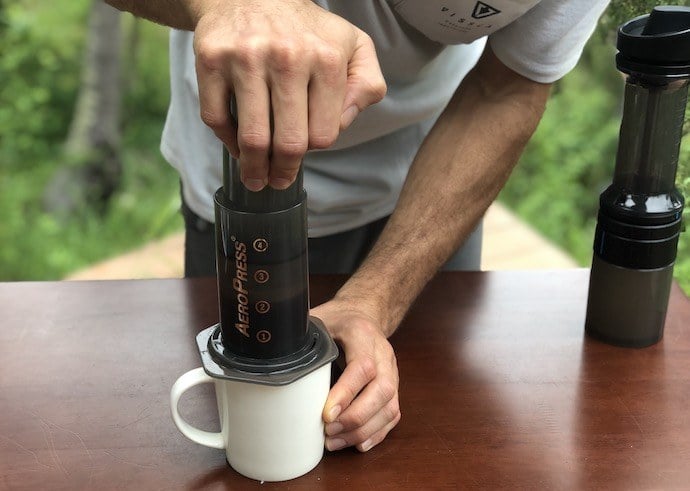 brewing aeropress coffee while pushing