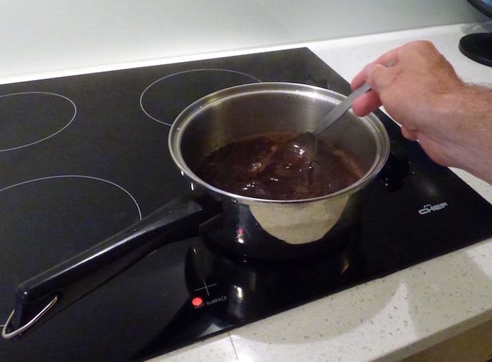 person stirring coffee in a pan