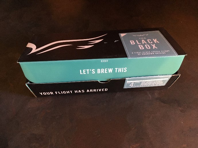 a shipping box of angel's cup coffee on a black counter top