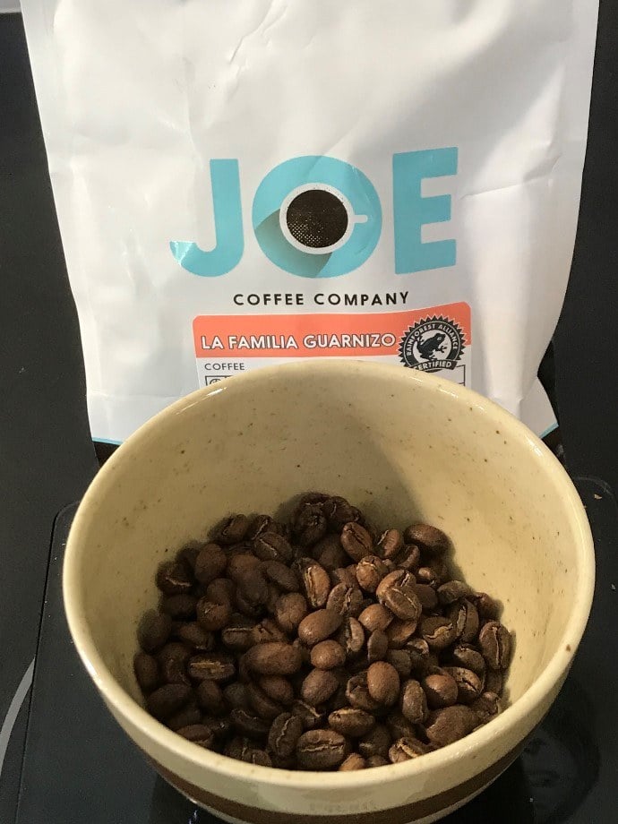 a packet of joe coffee and beans in a bowl