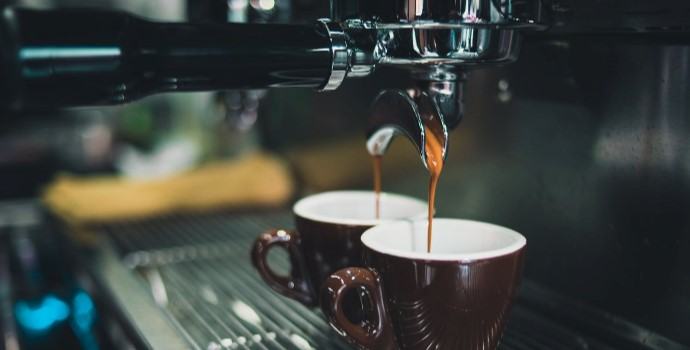 espresso being pulled into cappuccino cups