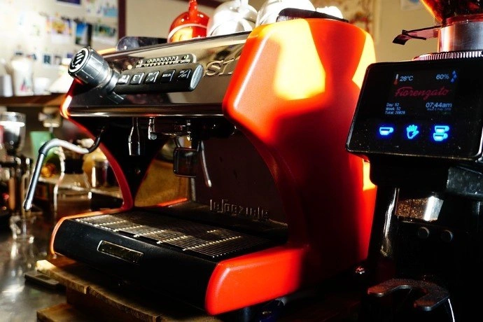 orange espresso machine from a side view