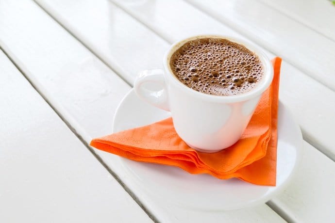 a cup of greek coffee on a saucer and napkin