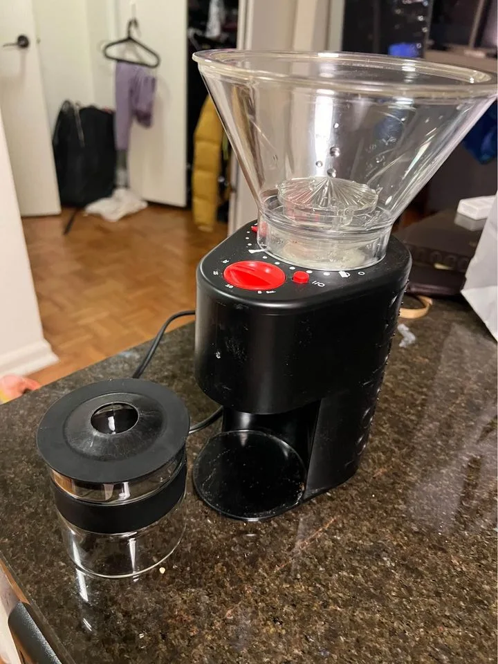 Bodum grinder next to its bean chamber