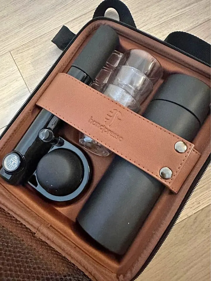 a closeup of a Handpresso leather carrying bag