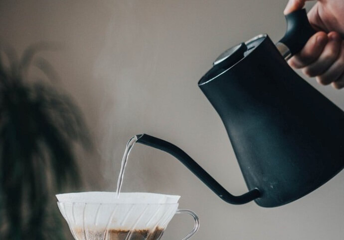 a fellow stagg gooseneck kettle pouring into a coffee maker