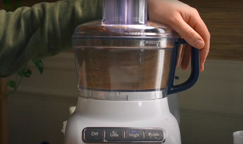 grinding beans in a white food processor