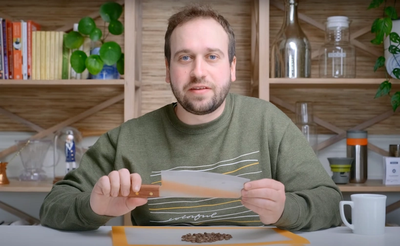 steven holding a knife ready to chop coffee beans