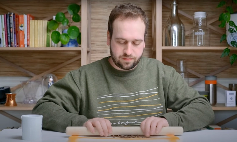 steven grinding beans with the rolling pin
