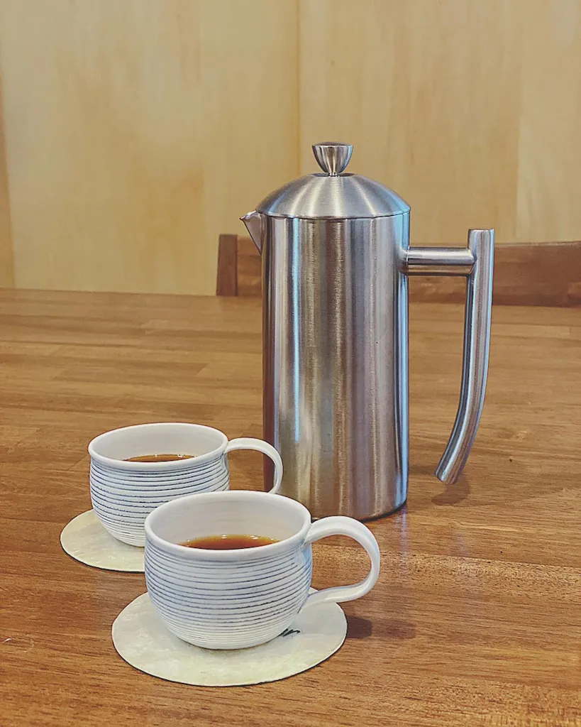 Frieling French press with white coffee cups