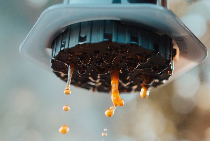 a close aeropress go review - coffee being pushed out of of the coffee maker