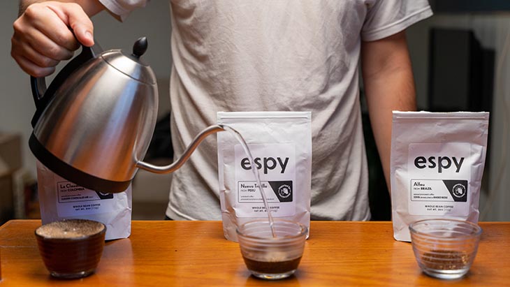 adding the water to the beans in a cup