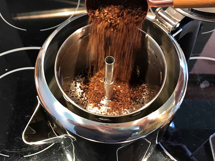 putting coffee into a percolator