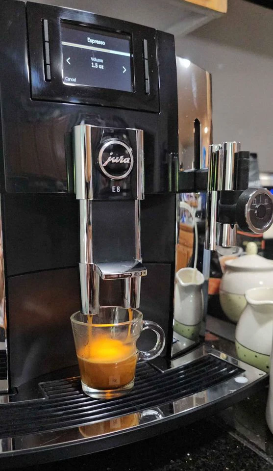Side view of a Jura E8 dispensing espresso