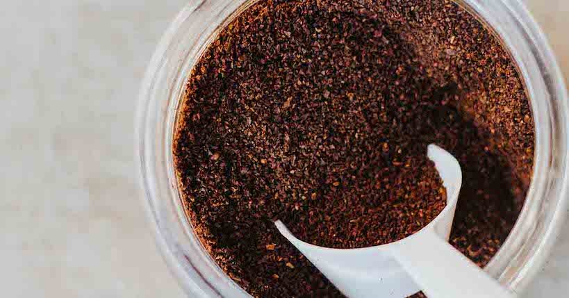 scooping grind coffee with a scoop