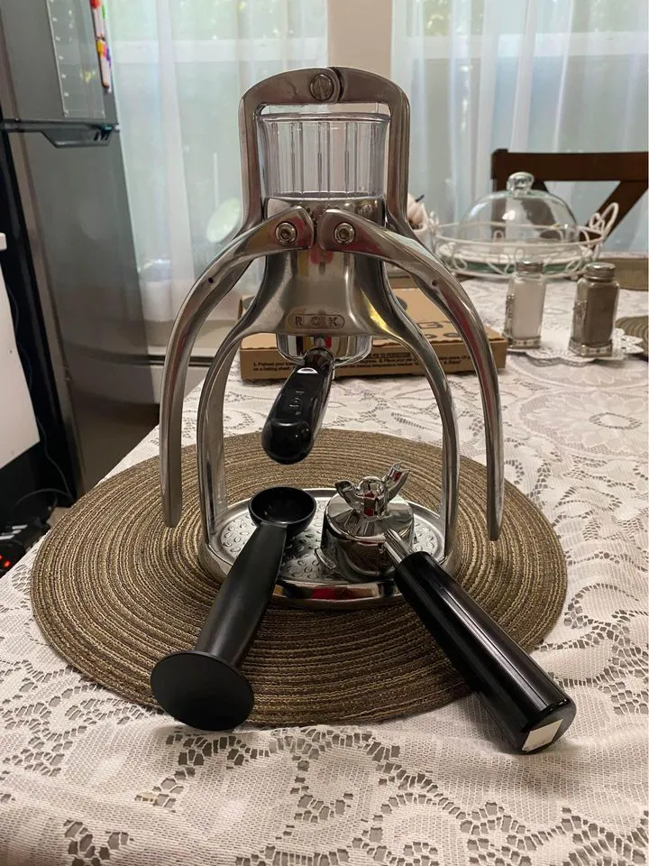Rok Espresso Maker with accessories on dining table
