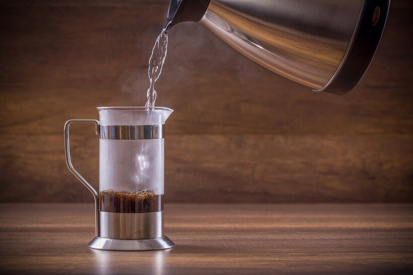 pouring water from the kettle into French press