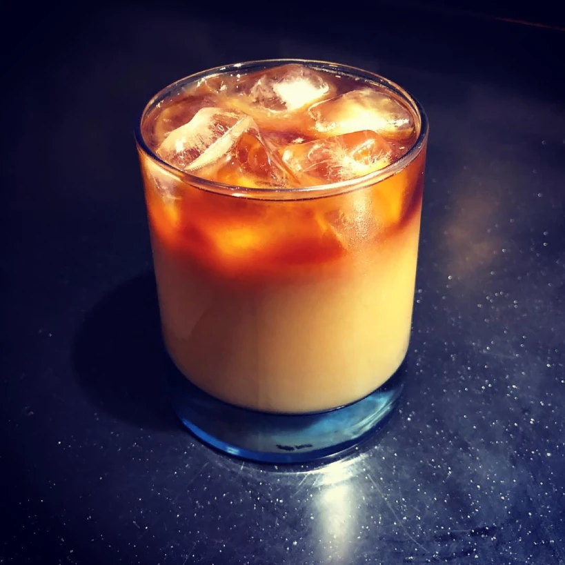 Glass of cold brew coffee with milk