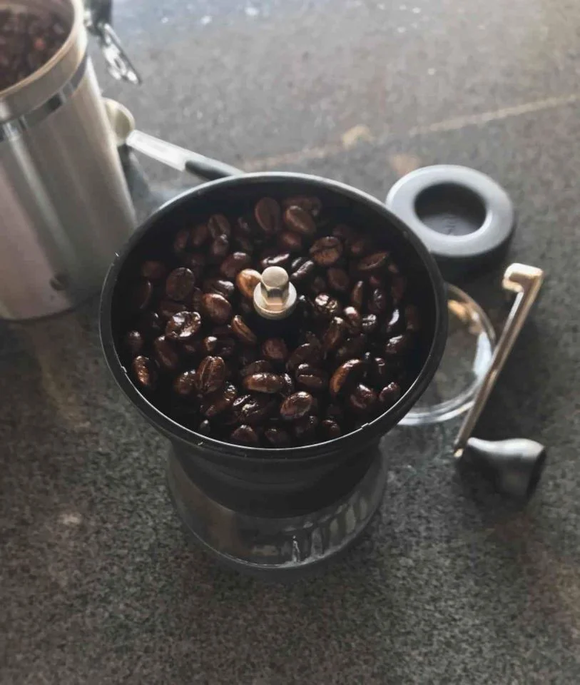 Hario Skerton hopper filled with coffee beans