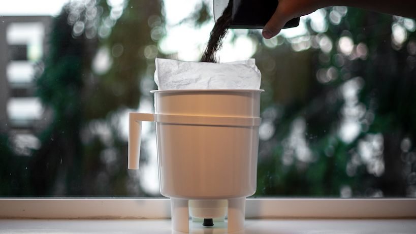 adding ground coffee to Toddy cold brew maker