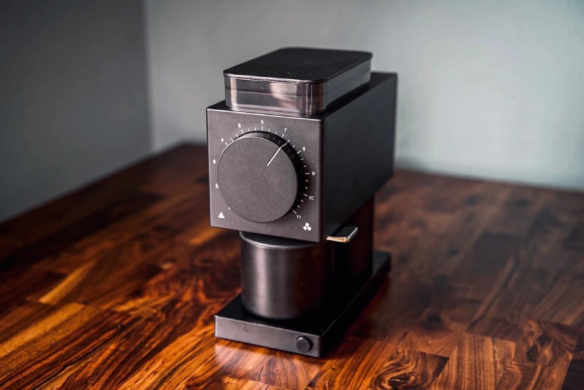 Fellow Ode coffee grinder on wooden bench