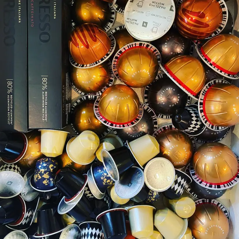 Pile of assorted Nespresso Original and Nespresso Vertuo capsules